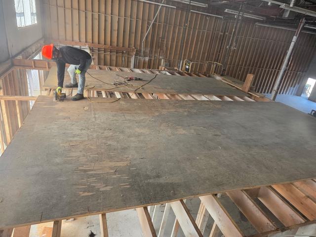 Plywood mezzanine deck being worked on in a commercial building