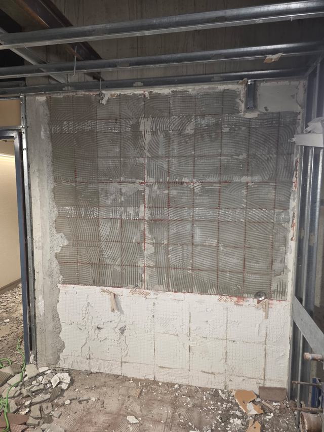 Wall tile removed back to the substrate, debris on the floor